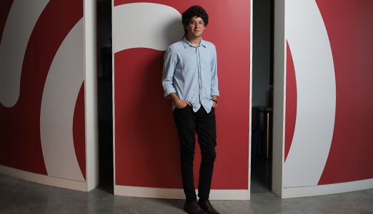 A person standing in front of a red wall with the Ordermark logo.
